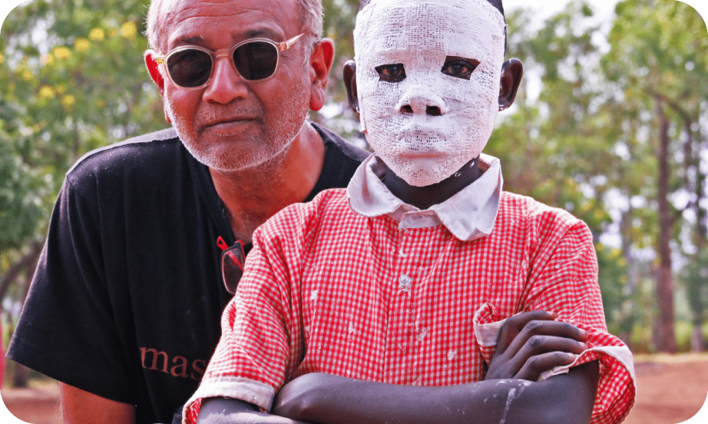 Teacher and student during mask making workshop Kenya