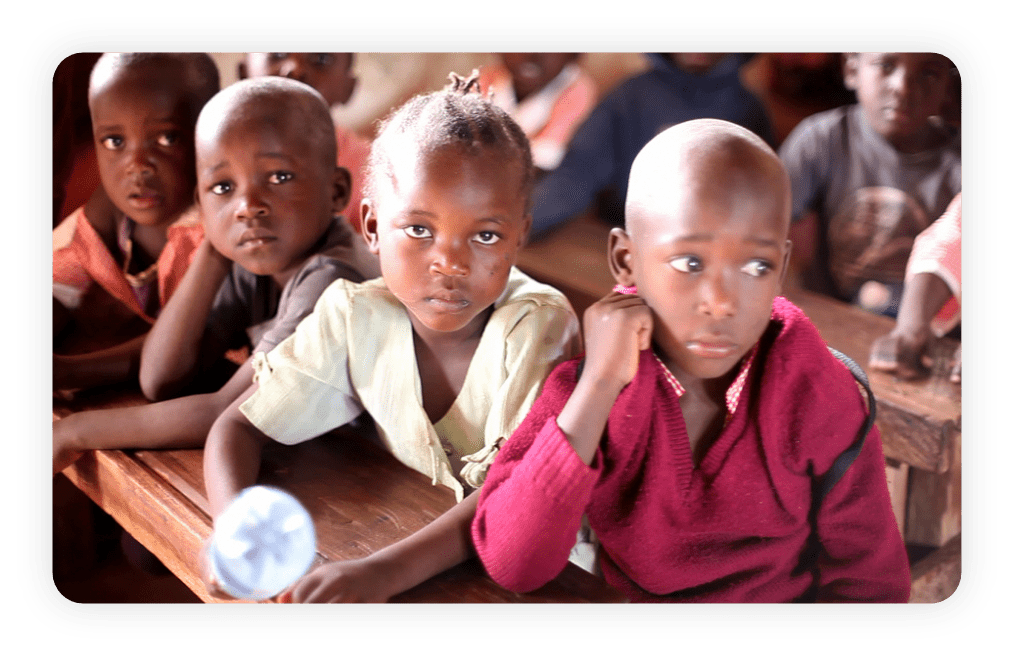 Children in Kenya listening to a storyteller.