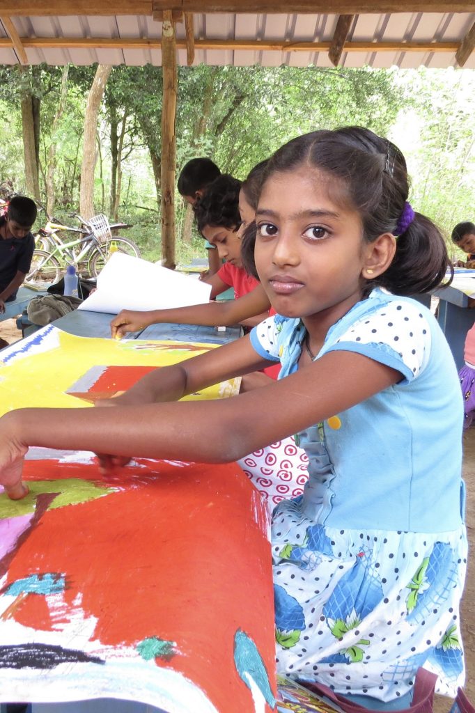 Girl in Sri Lanka drawing her recollection of the stories told by elders during a ChildsPlay Storytelling Event.