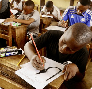 Boy in Ghana drawing the Sankofa symbol