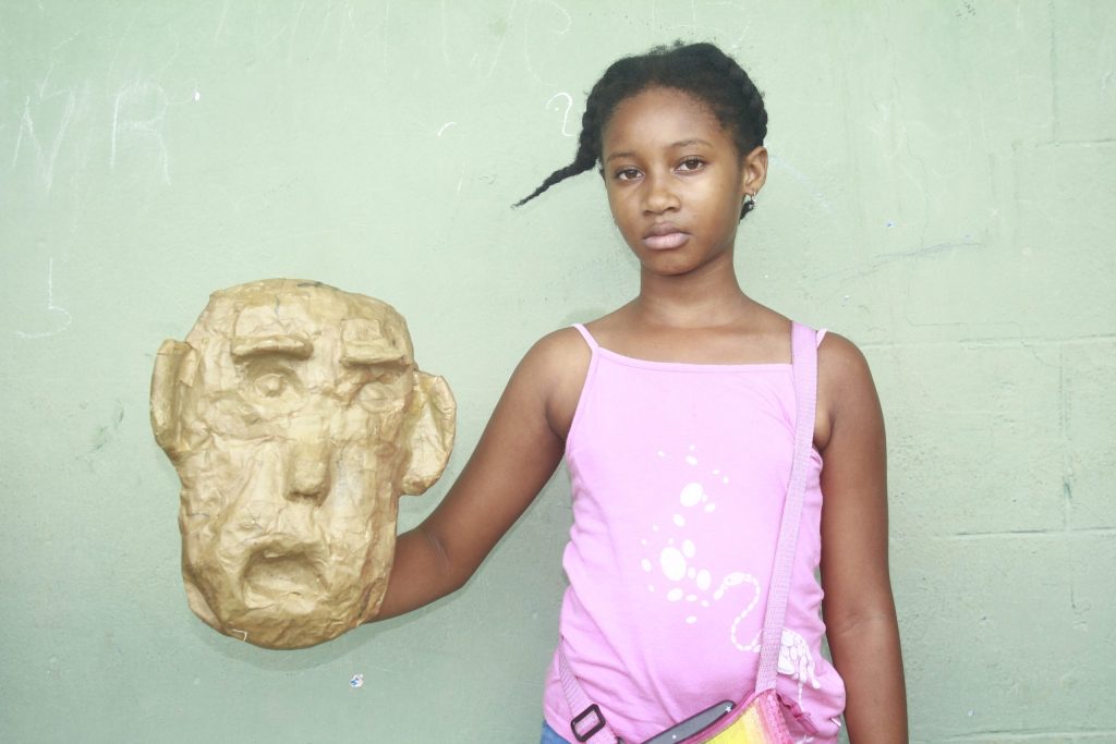 Girl at mask-making workshop in Haiti.
