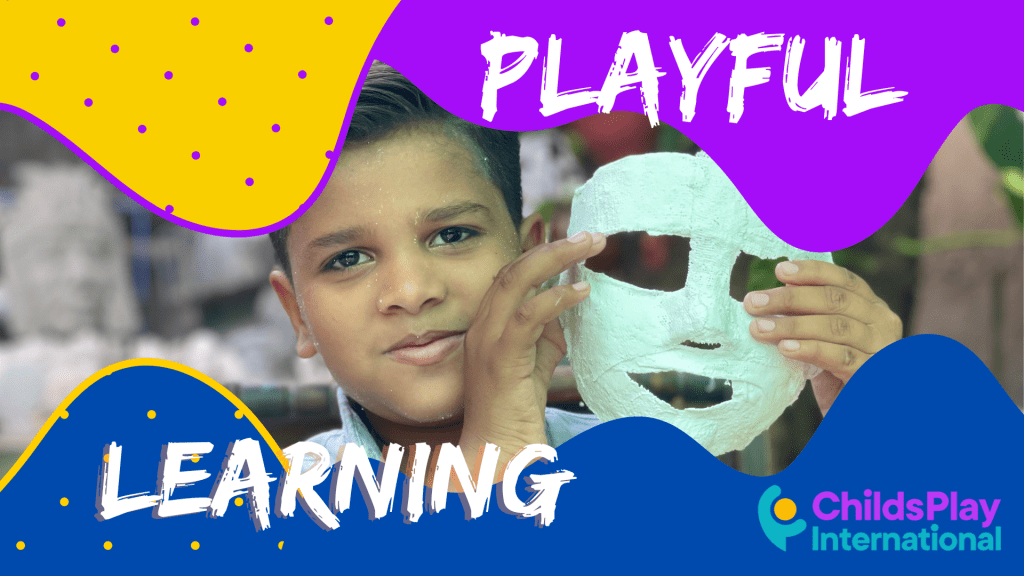 playful learning boy holding mask