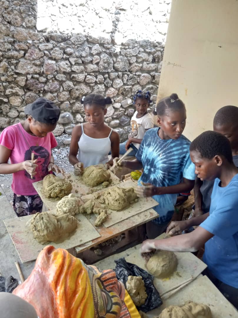 girls learning the art of Mask-making Haiti