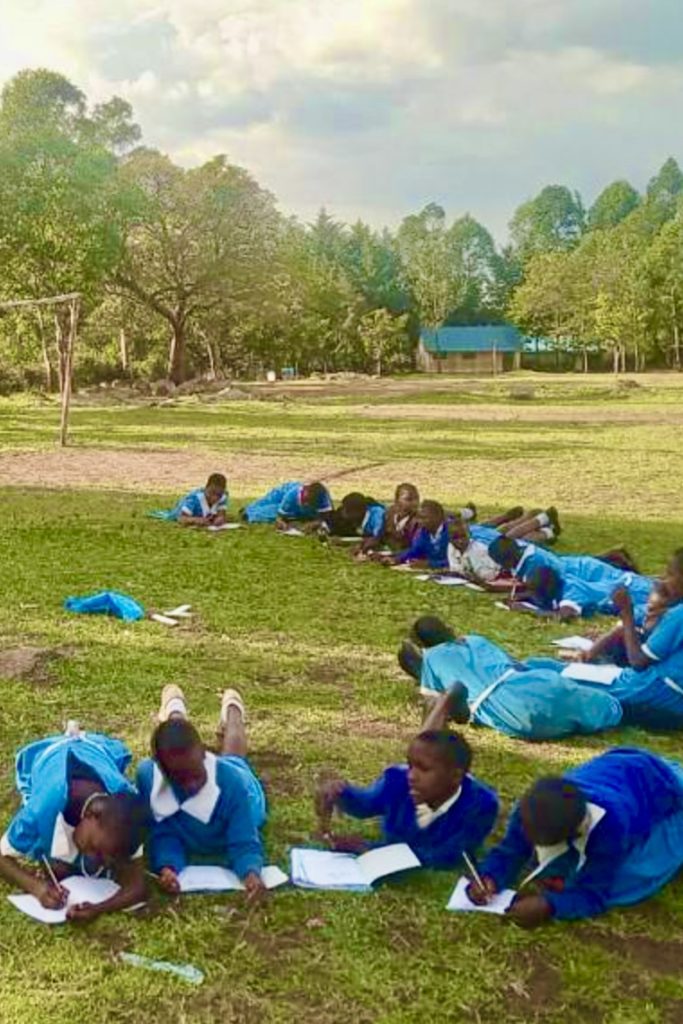 Girls studying outdoors in Kenya during CPI Storytelling class