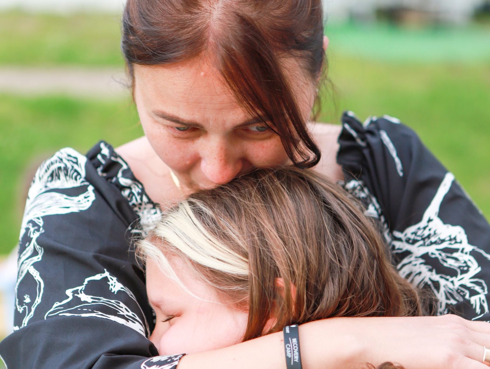 Mother embrace daughter during play